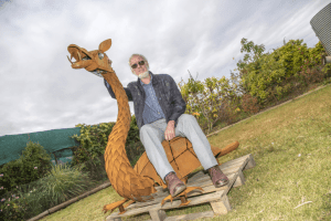 Image of Steve Cole with his sculpture of a Bunyip.  
